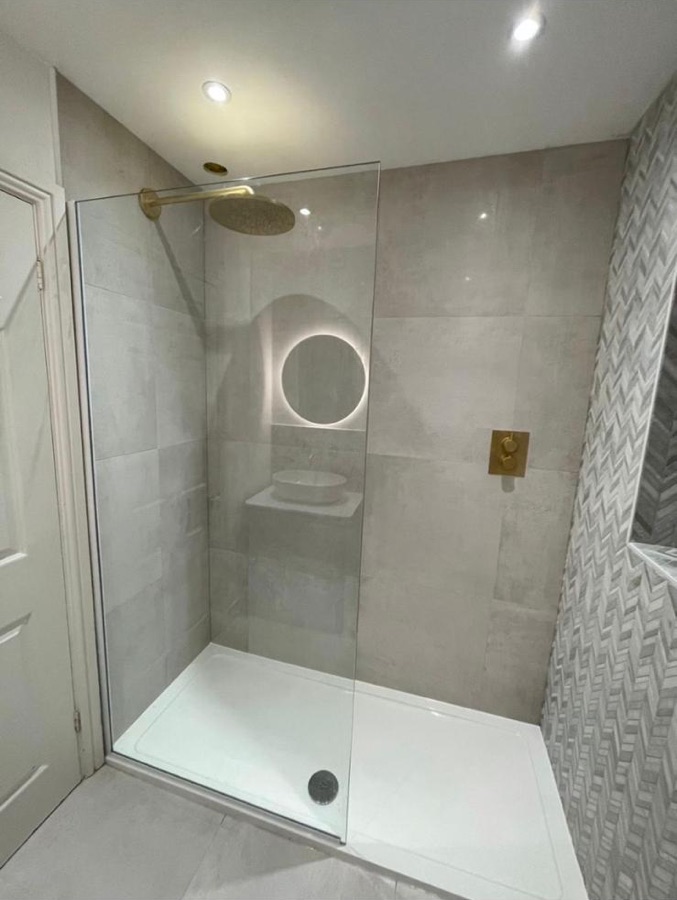 Walk-in shower with brushed brass rainfall head and concealed valve